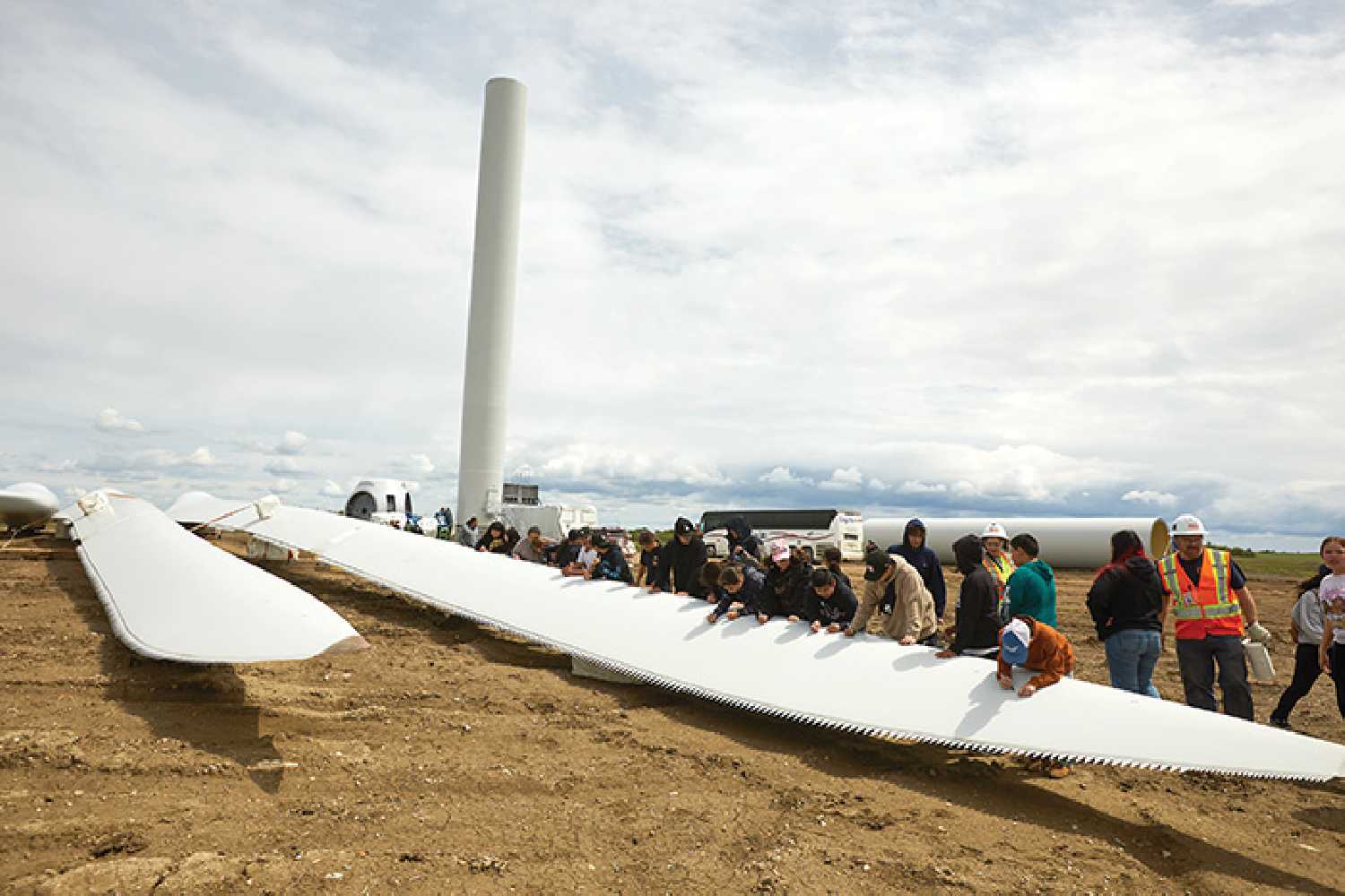 Cowessess youth signing a turbine blade.